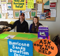Pace Law students Kiera Fitzpatrick and Patrick Van Hall working Hurricane Sandy Relief table 