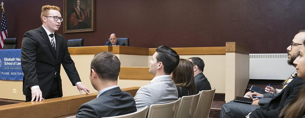 Student participating in a simulation class learning how to speak with a jury 